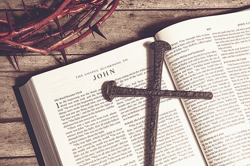 The crown of thorns, a bible and a cross.