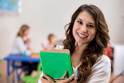 A smiling teacher with her students in class