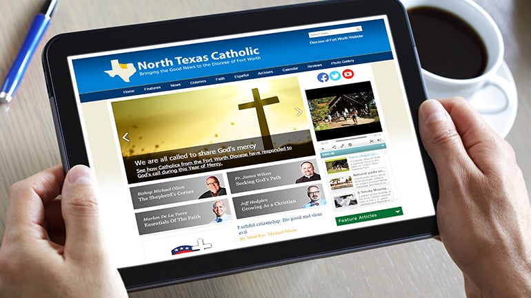 A person holding a tablet reads the North Texas Catholic newsmagazine.